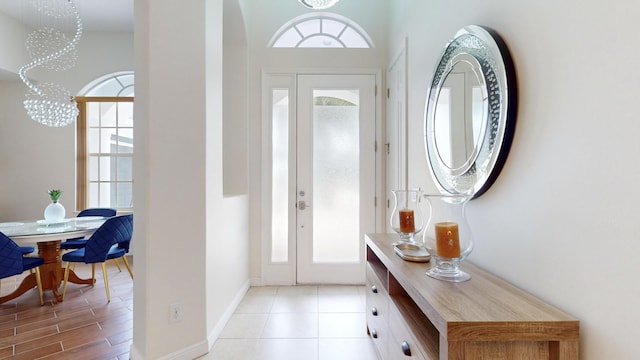 foyer entrance with a chandelier