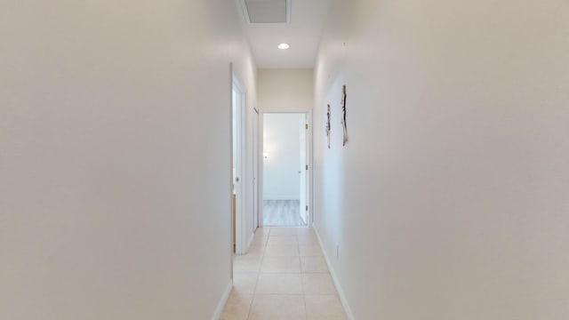 hall featuring light tile patterned floors