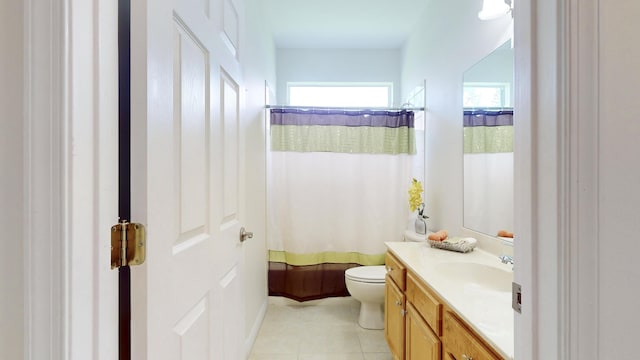 bathroom featuring tile patterned flooring, a shower with curtain, vanity, and toilet