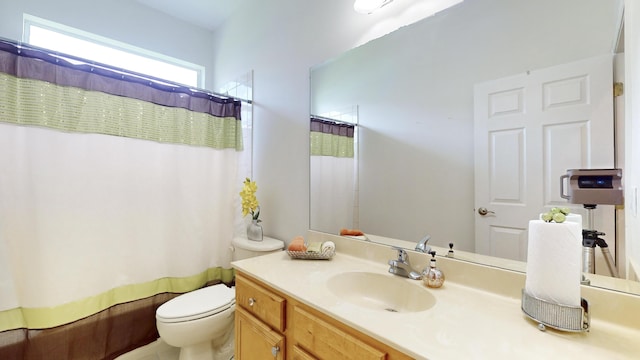 bathroom featuring vanity, a shower with shower curtain, and toilet