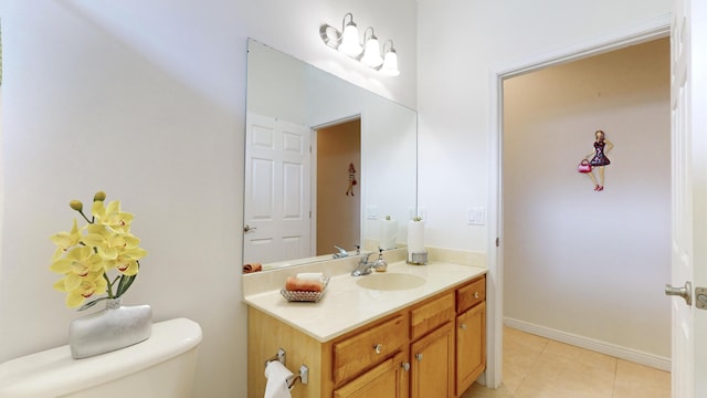 bathroom featuring tile patterned flooring, vanity, and toilet