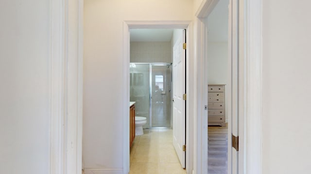 corridor with light tile patterned flooring