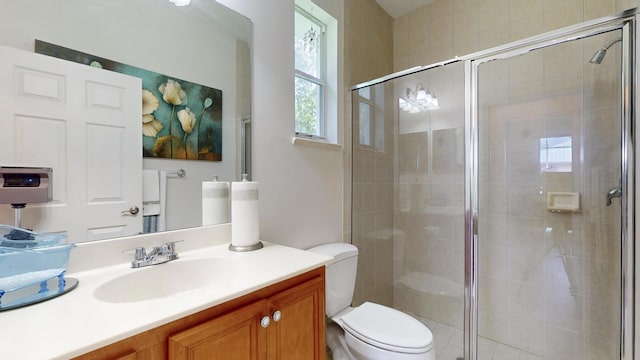 bathroom with vanity, toilet, and walk in shower