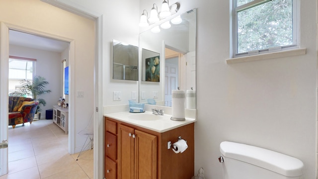 bathroom featuring tile patterned flooring, vanity, and toilet