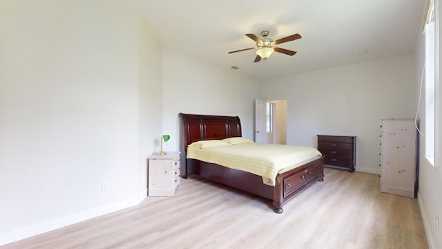 bedroom with ceiling fan and light hardwood / wood-style floors