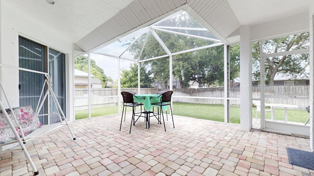 unfurnished sunroom featuring vaulted ceiling