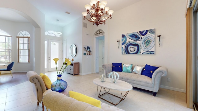 living room featuring light tile patterned flooring and an inviting chandelier