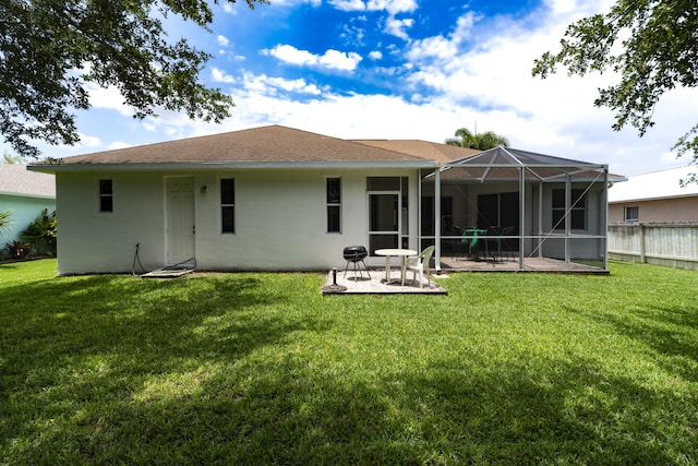 back of property with a patio area, a lanai, and a lawn