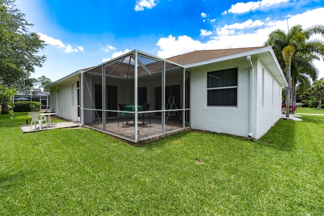 back of property featuring a lanai, a patio area, and a lawn