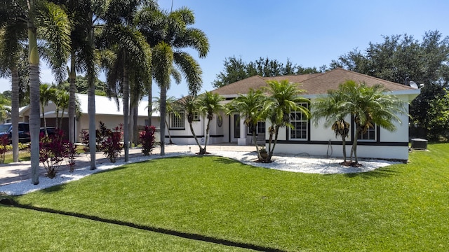 back of property with a lawn and central AC unit