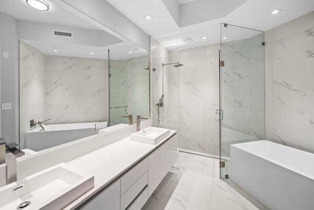 bathroom with vanity, tile walls, and independent shower and bath