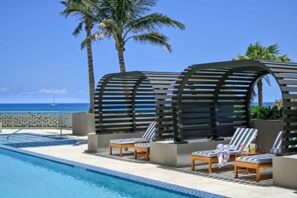 view of swimming pool featuring a patio and a water view