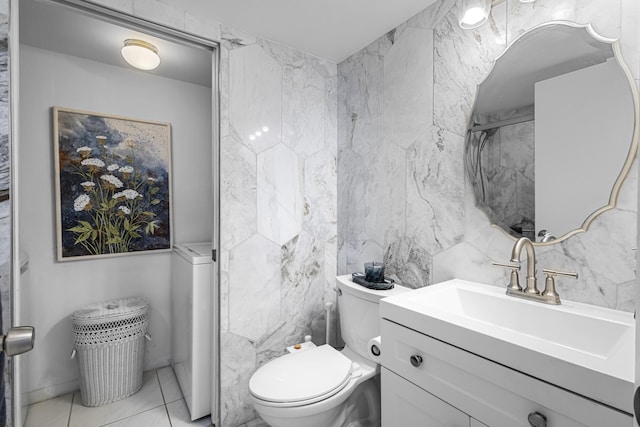 bathroom featuring tile patterned floors, vanity, toilet, and tile walls