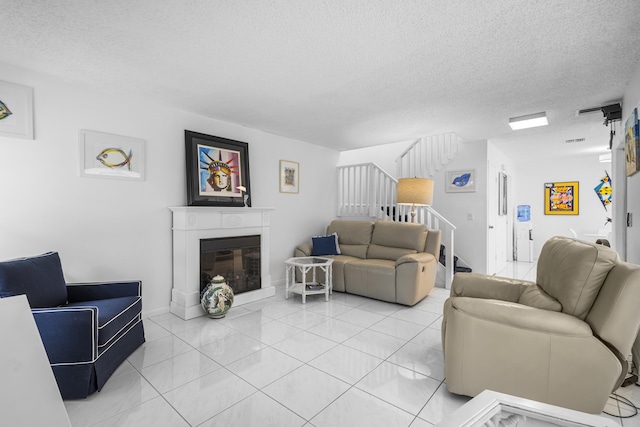 living room featuring light tile patterned floors and a textured ceiling