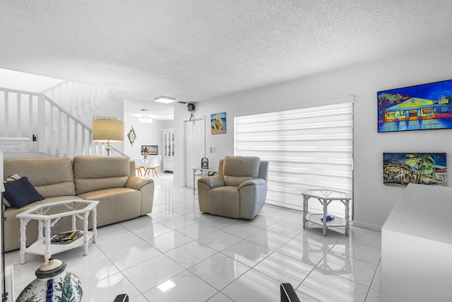 living room with light tile patterned floors and a textured ceiling