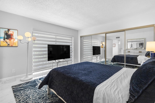 bedroom with a closet and a textured ceiling