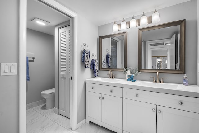 bathroom featuring vanity and toilet