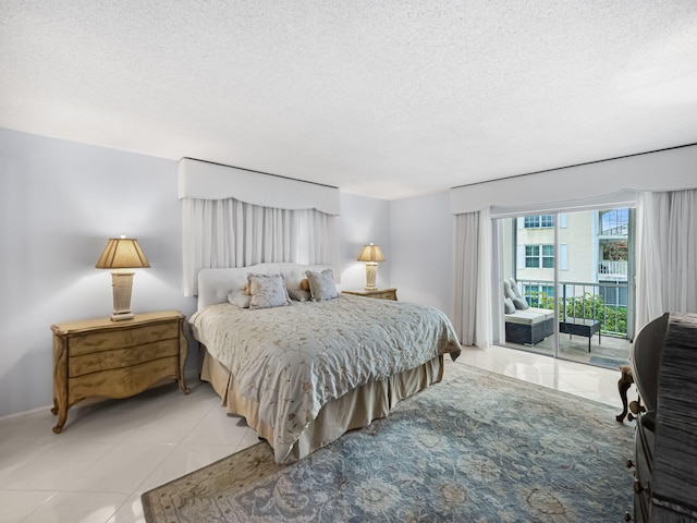 bedroom featuring light tile patterned floors, a textured ceiling, and access to outside