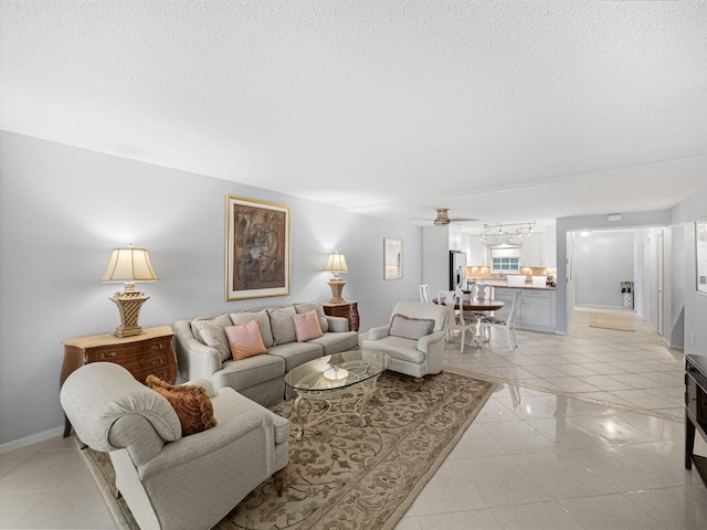 living room featuring light tile patterned floors, a textured ceiling, and ceiling fan