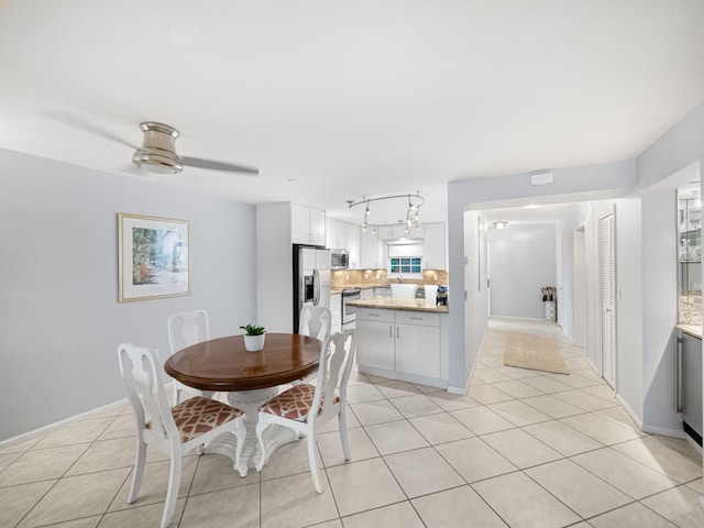 tiled dining room featuring ceiling fan