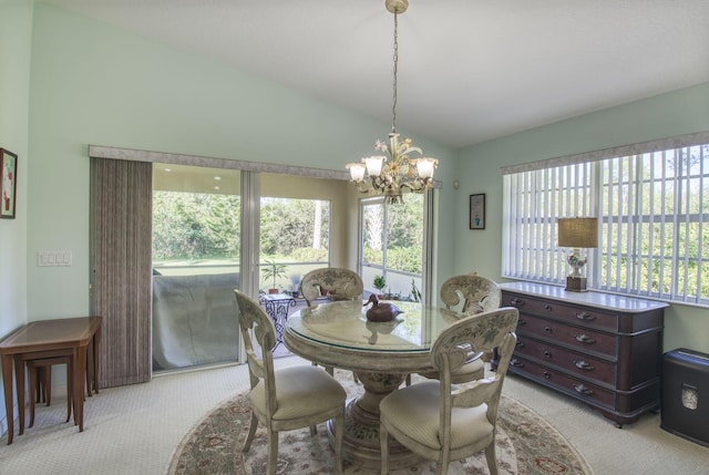 carpeted dining area with vaulted ceiling and a notable chandelier