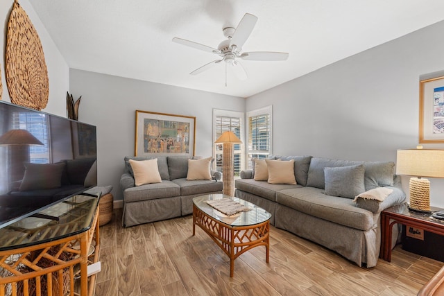 living room featuring ceiling fan and light hardwood / wood-style flooring