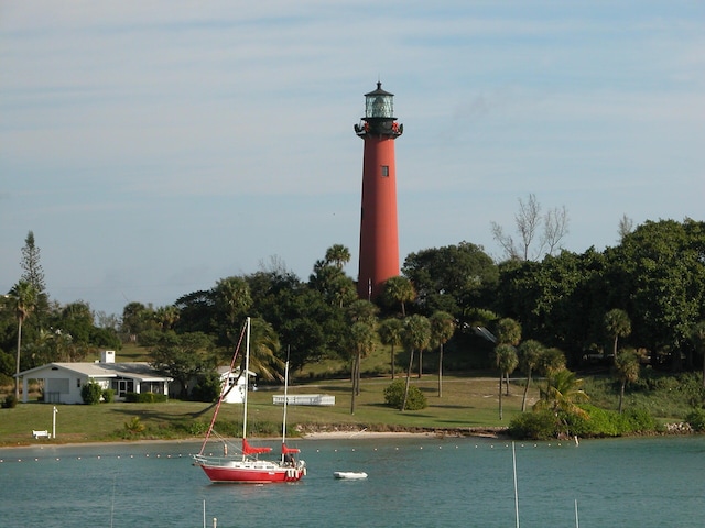 view of community with a yard and a water view