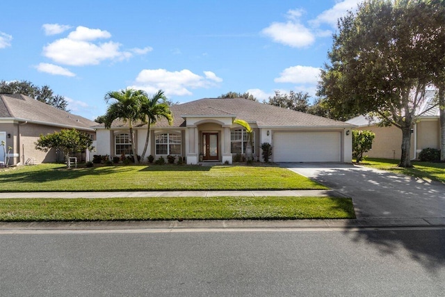 view of front facade with a garage and a front lawn