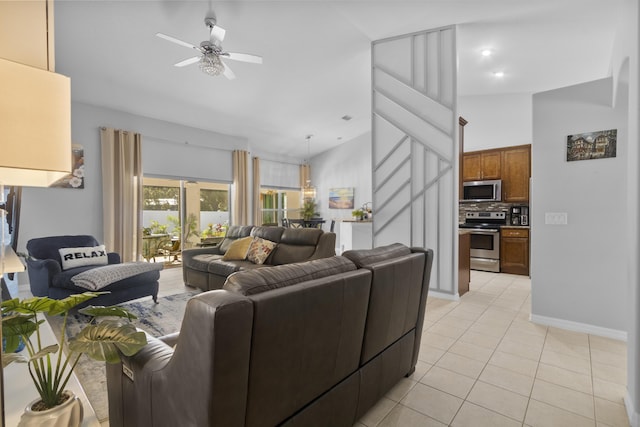 living room with ceiling fan, light tile patterned flooring, and lofted ceiling