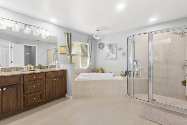 bathroom featuring tile patterned flooring, vanity, and shower with separate bathtub