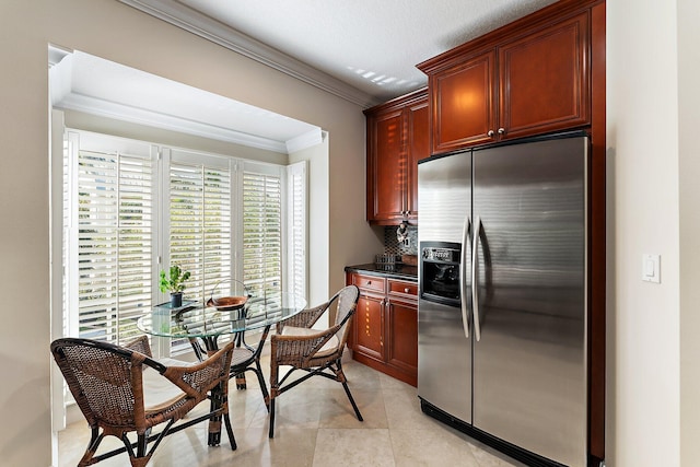 kitchen featuring light tile patterned floors, stainless steel refrigerator with ice dispenser, and ornamental molding