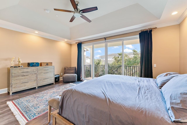 bedroom with a raised ceiling, ceiling fan, access to exterior, ornamental molding, and dark hardwood / wood-style flooring