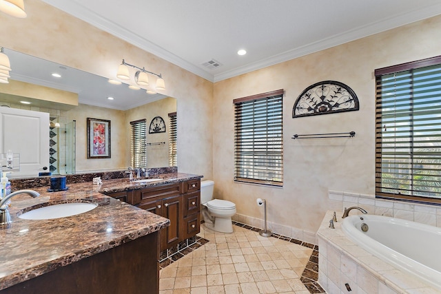 bathroom featuring tile patterned floors, vanity, crown molding, a relaxing tiled tub, and toilet