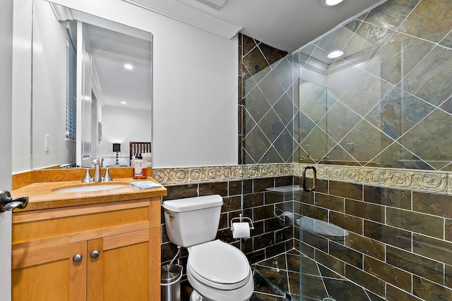 bathroom featuring walk in shower, vanity, toilet, and tile walls