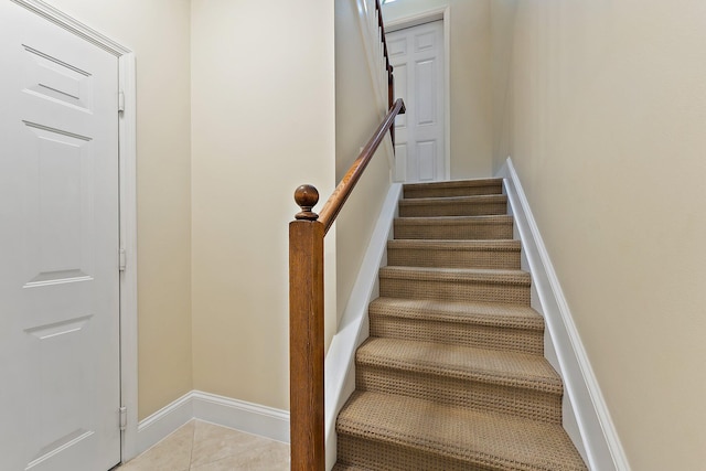 stairway with tile patterned flooring