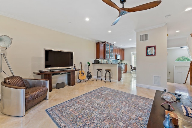 living room featuring ceiling fan and ornamental molding