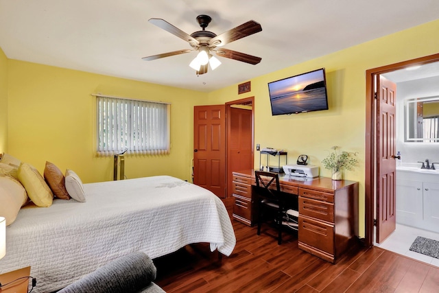 bedroom featuring ceiling fan, dark hardwood / wood-style flooring, sink, and connected bathroom