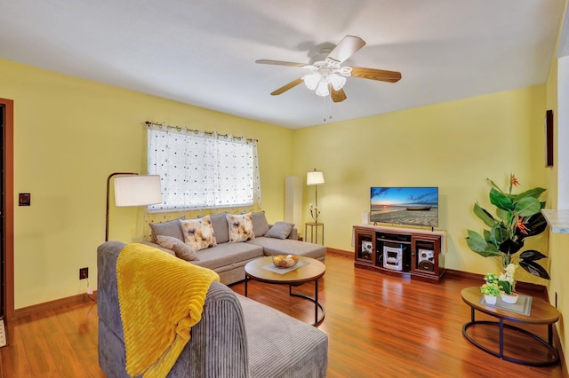 living room featuring ceiling fan and wood-type flooring