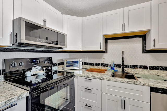 kitchen with white cabinetry, sink, and appliances with stainless steel finishes