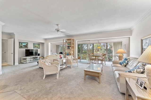 living room featuring light carpet, a textured ceiling, ceiling fan, and ornamental molding