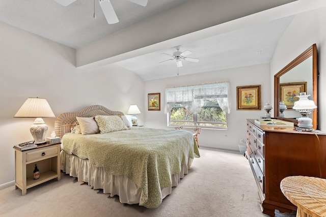 bedroom featuring a textured ceiling, ceiling fan, light carpet, and lofted ceiling