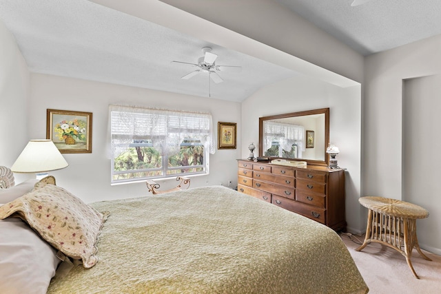 carpeted bedroom featuring a textured ceiling, vaulted ceiling, and ceiling fan