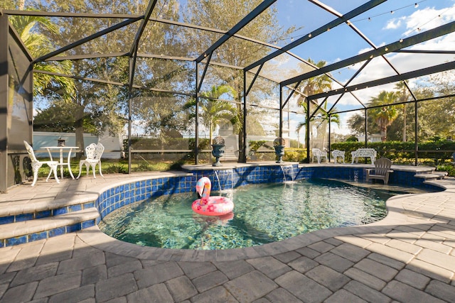 view of pool with pool water feature, glass enclosure, an in ground hot tub, and a patio