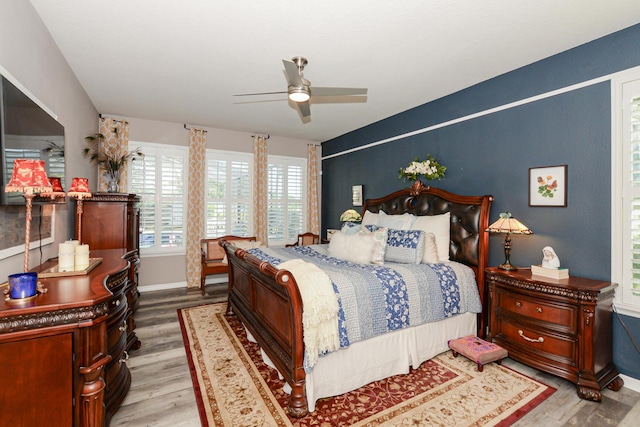 bedroom with ceiling fan and light hardwood / wood-style flooring