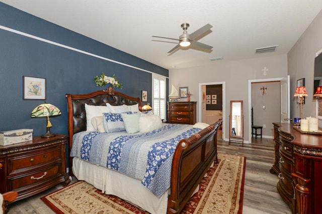 bedroom with wood-type flooring and ceiling fan