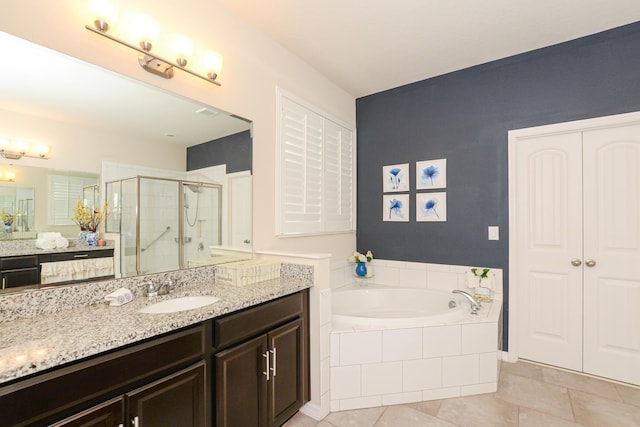 bathroom with tile patterned flooring, vanity, and separate shower and tub