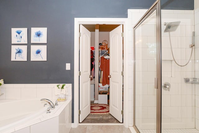 bathroom with tile patterned floors and separate shower and tub