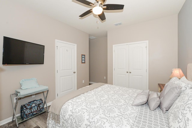 bedroom with ceiling fan, a closet, and wood-type flooring