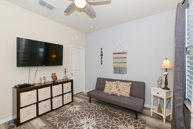 living room featuring hardwood / wood-style flooring and ceiling fan