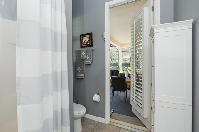 bathroom featuring toilet and tile patterned floors